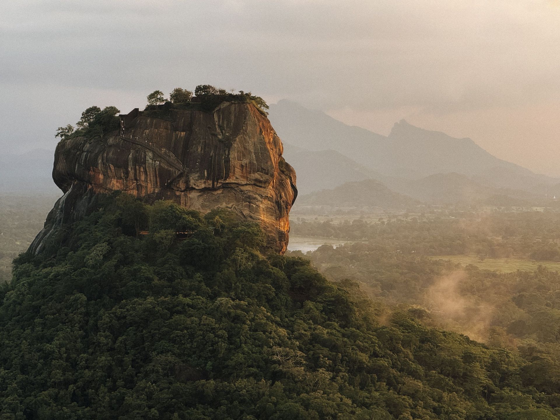 Vue aérienne époustouflante du Rocher de Sigiriya, paysage verdoyant et montagnes lointaines au Sri Lanka.